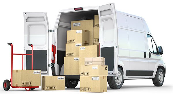 Professional man and van loading removal boxes into a transit van in West London.