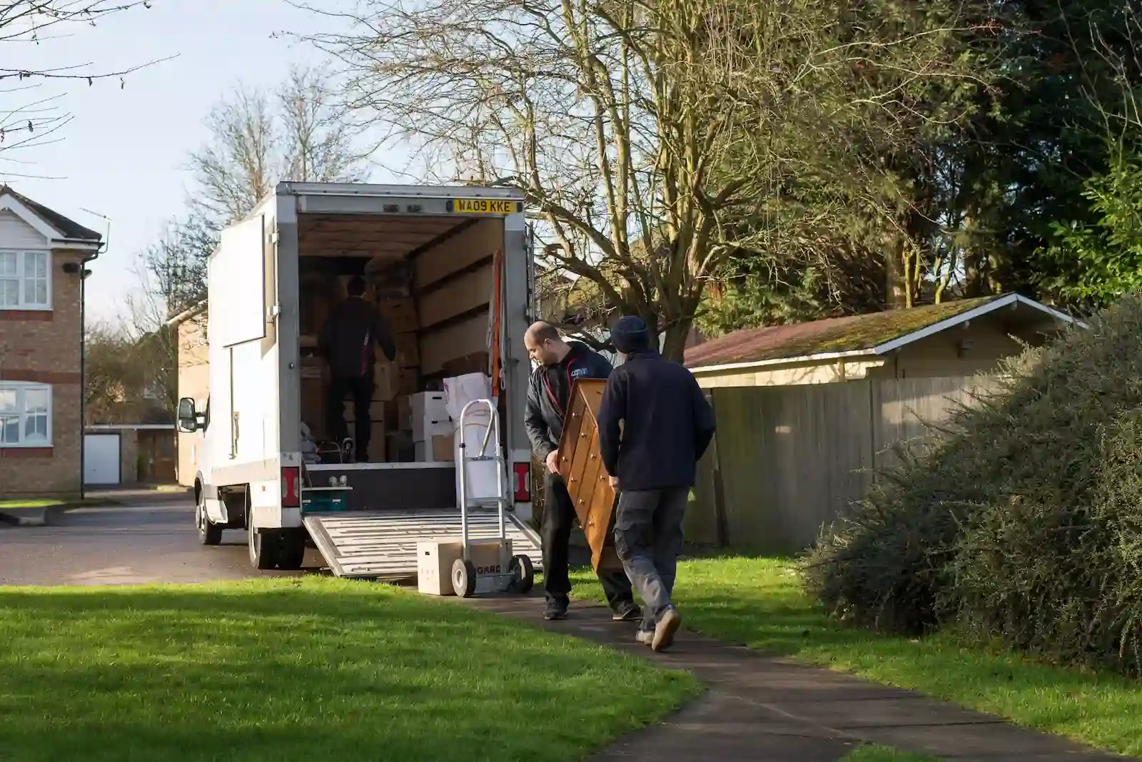 Professional removals South London team unloading a van in a residential street near Greenwich